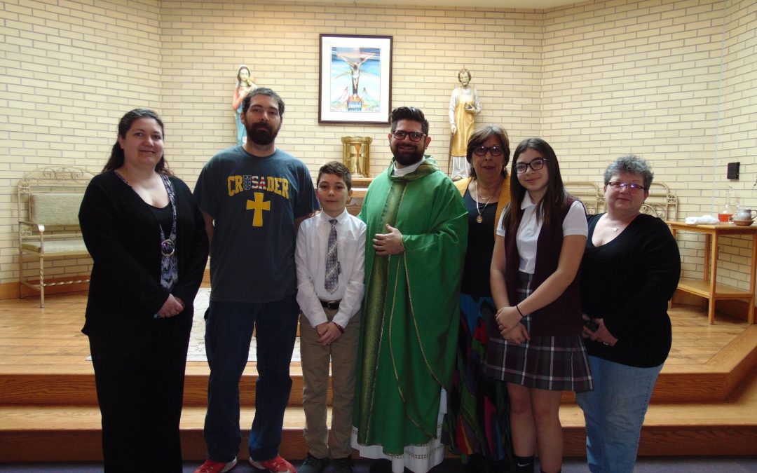 Sixth grader celebrates First Communion at school Mass